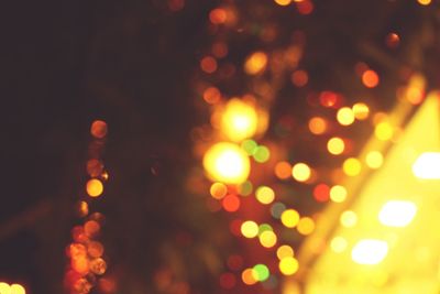 Defocused image of illuminated christmas tree at night