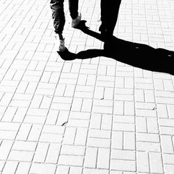 Low section of woman standing on tiled floor