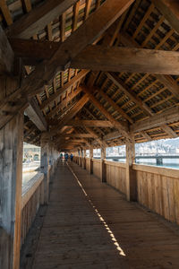 Lucerne, switzerland, march 10, 2022 pedestrian walkway inside the famous old chapel bridge 
