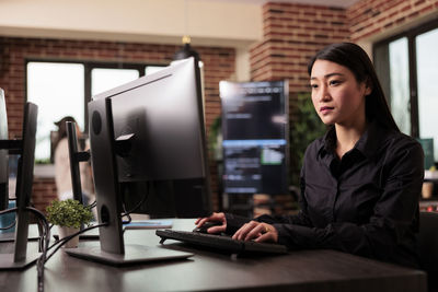 Portrait of businesswoman working at table