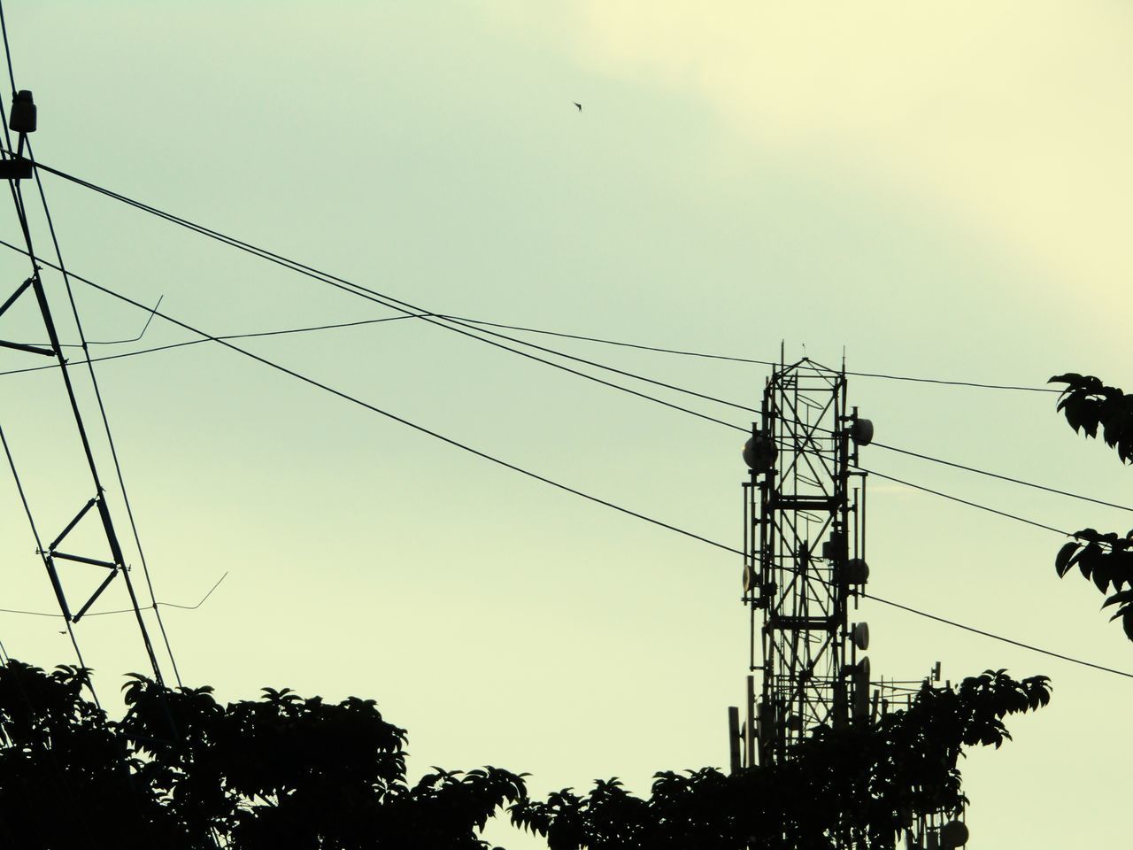 LOW ANGLE VIEW OF SILHOUETTE ELECTRICITY PYLONS AGAINST SKY
