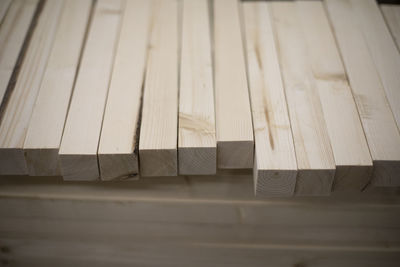 Boards in stock. wooden blanks. bars made of wood of light color. details of steelwork.