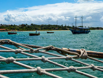 Fishing net against river and cloudy sky on sunny day