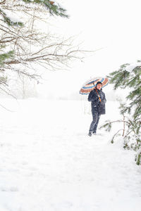 Full length of man skiing on snow covered field