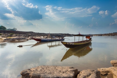 Boat moored in sea against sky