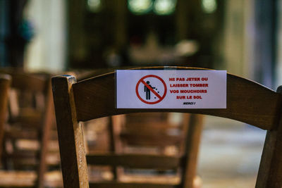 Close-up of information sign on railing