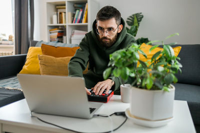 Young man using laptop at home