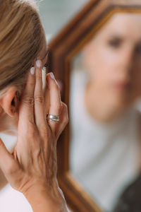 Concept of body dysmorphic disorder concept, woman looking at mirror obsessively.