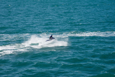 Man riding surfing in sea