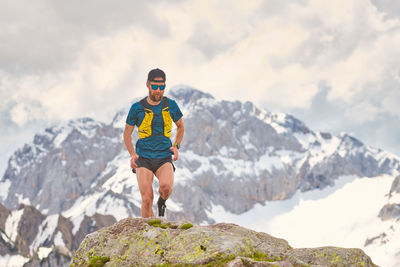 Trail running athlete in the mountains on rocks