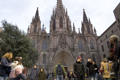 Group of people outside temple against building