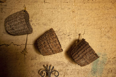 High angle view of wicker basket hanging from wall