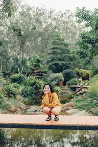 Portrait of woman sitting on boat in park