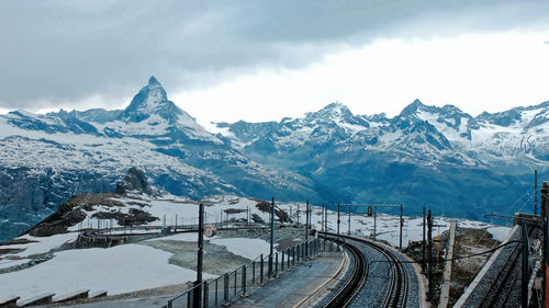 Scenic view of snowcapped matterhorn against cloudy sky