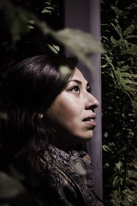 Side view of woman standing by plants