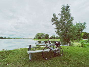 Bicycles on field against sky