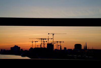 Silhouette buildings against sky during sunset