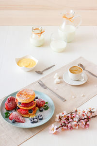Mille feuille, high angle view of french dessert on table with summer berry fruits and lemon curd.
