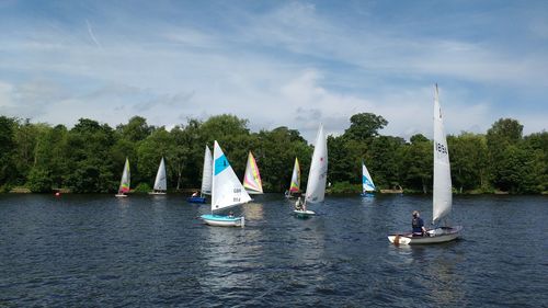 Boats sailing on sea against sky