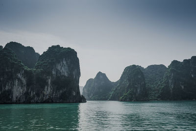 Scenic view of sea and mountains against sky