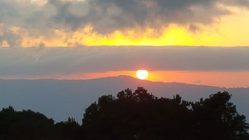 Scenic view of dramatic sky over sea during sunset