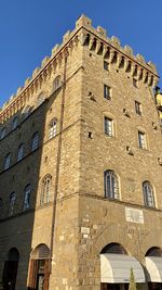 Low angle view of historical building against blue sky