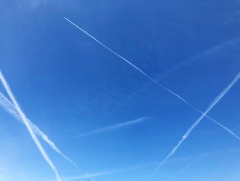 Low angle view of vapor trails in sky