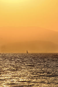 Scenic view of sea against orange sky