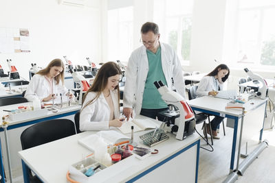 Students and teacher working in science class