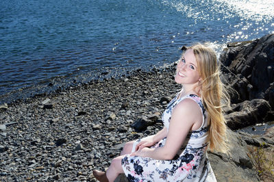 Portrait of woman sitting on beach