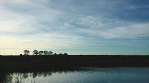 Scenic view of landscape against cloudy sky