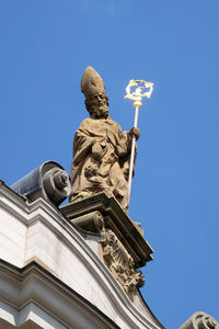 Low angle view of statue against blue sky