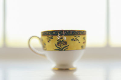 Close-up of coffee cup on table