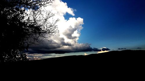 Low angle view of silhouette land against sky