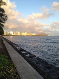 View of sea against cloudy sky at sunset