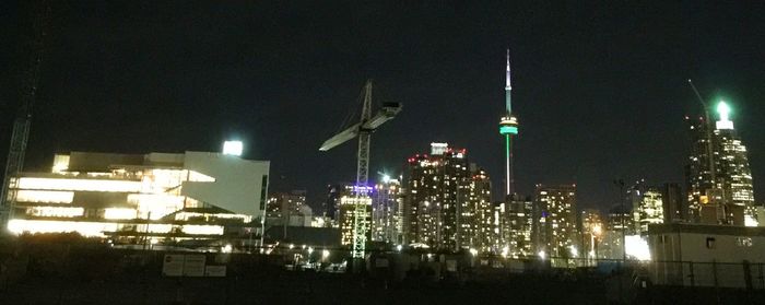 Low angle view of modern buildings against sky at night