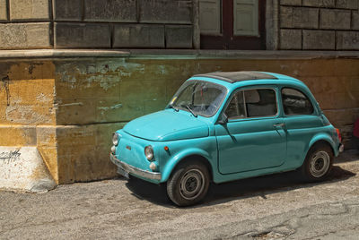 Vintage car against wall in city