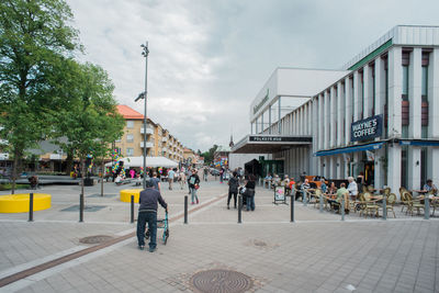 People in city against sky