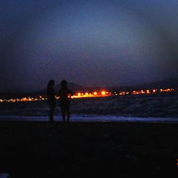 Silhouette of woman standing at night