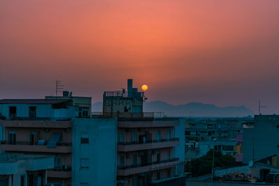 High angle view of buildings against sky during sunset