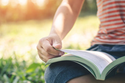 Close-up of hand holding book
