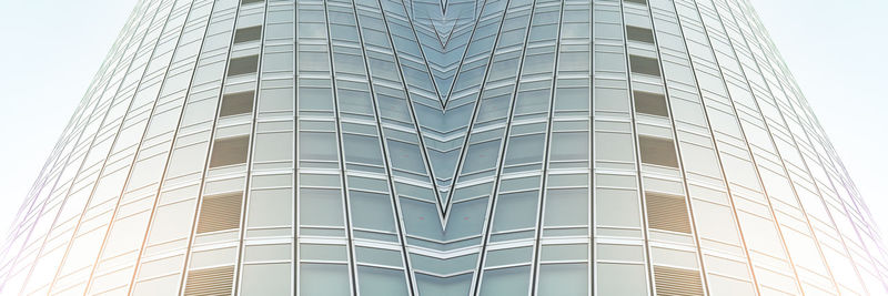 Low angle view of modern glass building against clear sky
