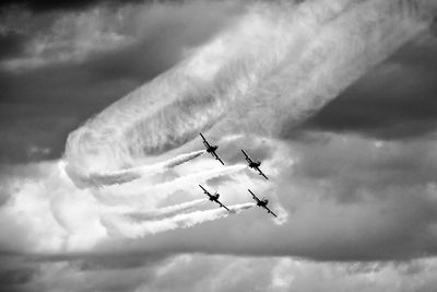 Low angle view of airplane flying against sky