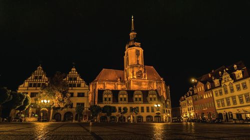 Illuminated buildings in city at night