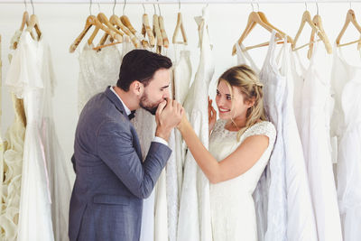 Young couple standing against wall