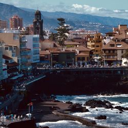 High angle view of buildings by sea against sky