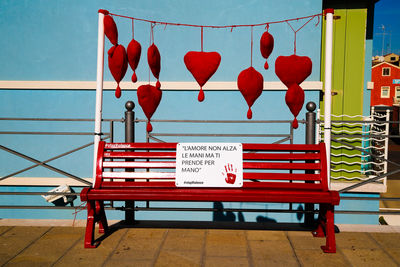 Empty bench on table against wall