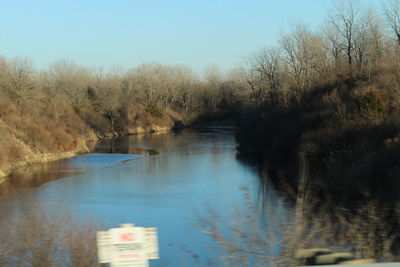 Scenic view of lake and trees against clear sky