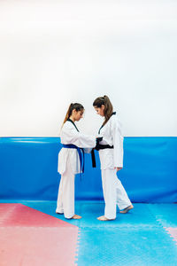 Young women wearing belt during taekwondo practice