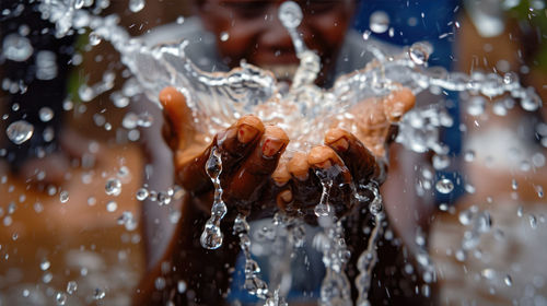 Low section of person splashing water